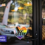 Welcoming LGBTQ+ Straight Ally Heart Sticker Displayed on glass bakery front door